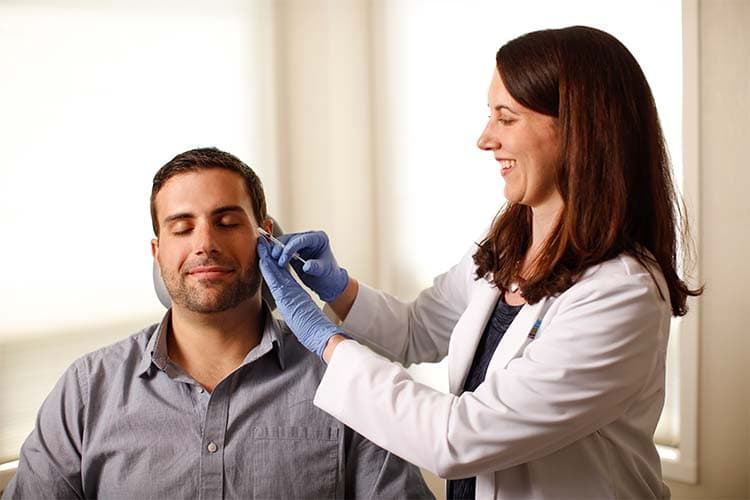 Male patient being injected on the face