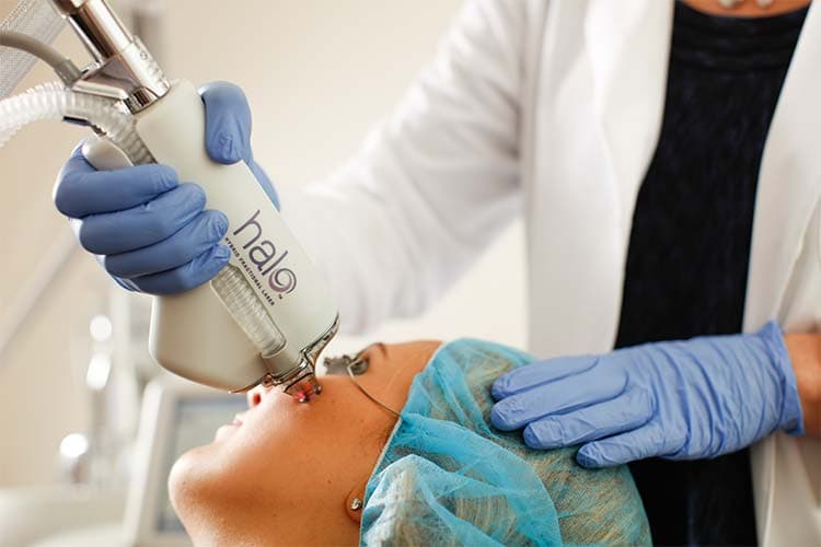 Patient receiving a HALO treatment on her face