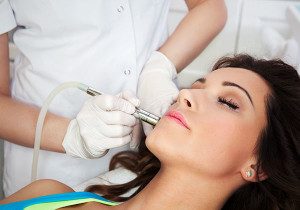 woman in treatment room getting microdermabrasion