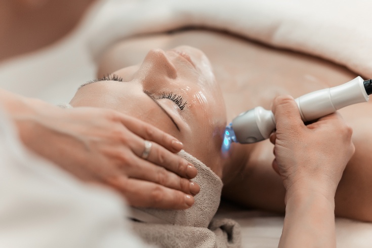 Patient lying on table during laser skin treatment