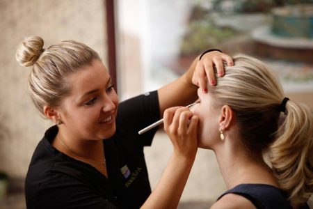 Applying makeup to woman's face