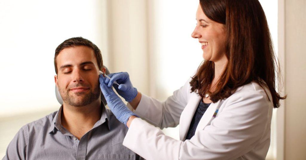 Dr. Lesley Loss performs a BOTOX treatment on a male patient.