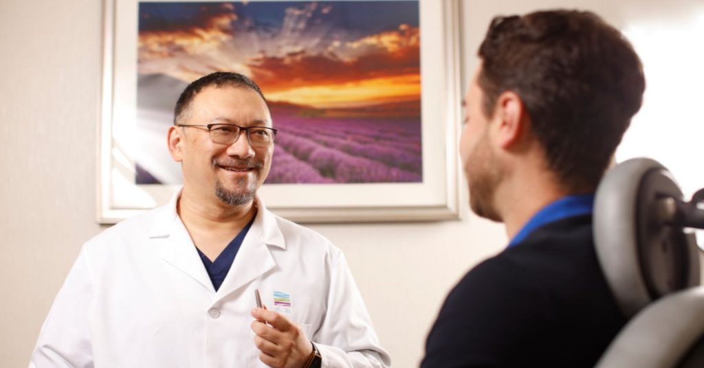 Dr. John Tu consulting with a patient.