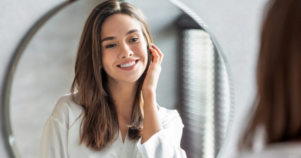 Woman with clear skin after laser treatment for acne scars. (Model)